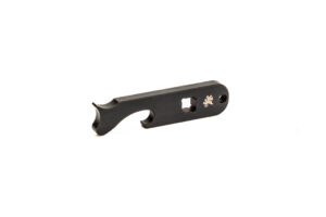 A black Griffin Armament Micro Carry Compensator keychain multitool wrench and tactical bottle opener with flathead screwdriver